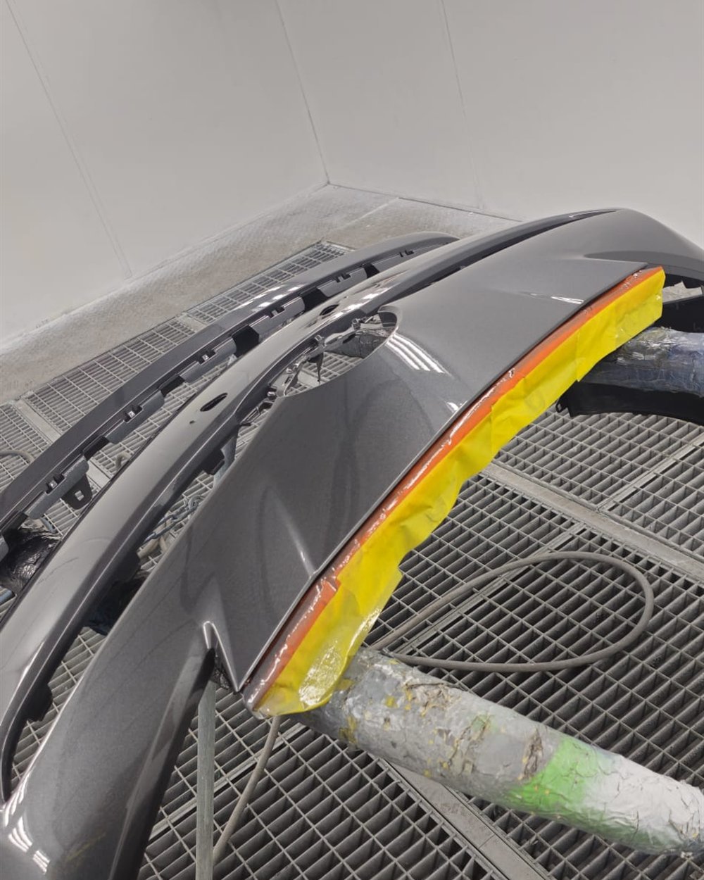 A scuffed bumper masked off for a localised SMART repair